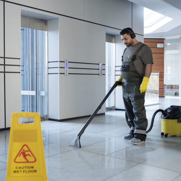 full-shot-man-vacuuming-floor